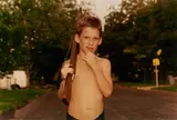 Bryan Rindfuss, Untitled (Boy with Rifle),, Chromogenic print; signed 'Bryan Rindfuss' in ink on the verso; matted
