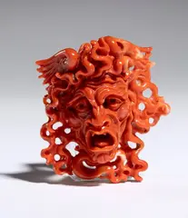 Coral carving depicting the head of Medusa by Carlo Parlati, entirely carved from a single branch of Cerasuolo coral (Corallium elatius) of exceptional chromatic quality., offered Sep 2026