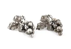 Nature Collection: a pair of silver bunches of grapes by Mario Buccellati, Each piece features a large embossed vine leaf with veins finely engraved using a burin, offered Sep 2026