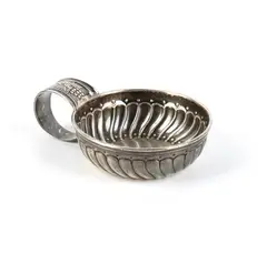 Sterling silver tastevin by Mario Buccellati, in the classical French and European tradition. The bowl features a shoulder decorated with a dense pattern of, offered Sep 2026