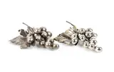 Mario Buccellati, Nature Collection: a pair of silver bunches of grapes, Each piece features a large embossed vine leaf with veins finely engraved using a burin