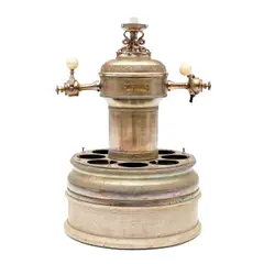 Lippincott Soda Fountain Syrup Dispenser, Untitled, 1900, cylindrical shape with double tap, surrounding wells for six glass fountain flavor dispensers