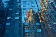 Mirrored reflections (skyscraper) by American School, oil on canvas, sold Jul 2023