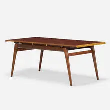 Robin Day, Dining table, 1949, figured English walnut, lacquered mahogany, mahogany, maple inlay, brass