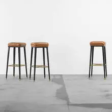 Jansen, stools, set of three, c. 1960, lacquered wood, leather, brass