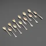 Tiffany & Co., Rare coffee spoons, set of twelve, 1907-1947, sterling silver parcel-gilt, mixed metals, enamel, niello (metal alloy inlays)