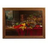 Eduard Huber-Andorf, A still life of fruit on a partial gilt silver tray with a lobster and a basket of grapes with other vessels on a draped table with a fountain beyond, oil on canvas