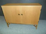 Borge Mogensen, A DANISH OAK CABINET, of two doors with brass handles
