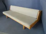 A DANISH OAK FRAMED DAY-BED, with adustable back support by Hans J. Wegner, sold Jul 2012