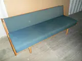 Hans J. Wegner, AN DANISH OAK DAYBED, with blue wool upholstery, adjustable backrest