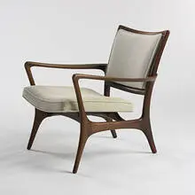 lounge chair by Vladimir Kagan, c. 1957, walnut, upholstery, sold Mar 2007