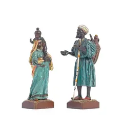 Franz Bergman, Two cold painted bronze figures of a male beggar and a female beggar carrying a baby on her shoulders, cold painted bronze
