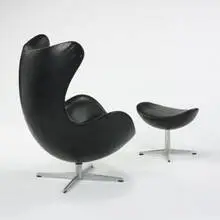 Egg chair and ottoman by Arne Jacobsen, 1958, leather-upholstered fiberglass, aluminum, sold Mar 2007