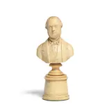 A mid 19th century carved ivory miniature bust of Camillo Benso, Count of Cavour, the sitter with mutton chop whiskers wearing a tied stock, coat and waistcoat, on turned circular socle and tapering cylindrical low pedestal, 13cm high overall by Carved ivory bust of Camillo Benso Cavour, offered Feb 2022