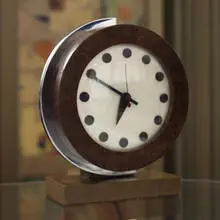 table clock from the 1933-34 World's Fair, model #4084B by Gilbert Rohde, 1934, walnut burl, ash, enameled metal, chrome-plated steel, sold Mar 2007