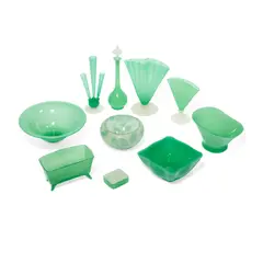 Group of Ten Table Objects by Frederick Carder, for Steuben, jade glass, comprising three vases, five bowls, one covered box, one decanter with stopper, sold Aug 2021