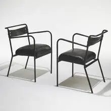 armchairs, pair by Jacques Adnet, c. 1950, leather over steel, sold Mar 2006