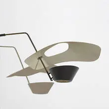 wall mounted lamp by Pierre Guariche, c. 1953, perforated and enameled metal, brass, sold Mar 2006