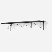 coat rack by Mathieu Matégot, c. 1956, perforated and enameled steel, enameled brass, sold Mar 2020