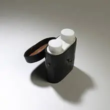 Binoculars by Not Vital, white marble in leather case, sold May 2004