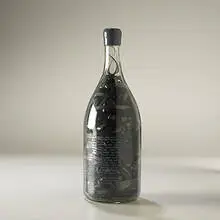 Tape Fall by Christian Marclay, 1990, glass bottle, magnetic tape, sold May 2004