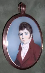 English School, A Gentleman, wearing brown coat over white waistcoat and tied cravat, oval yellow metal frame, the rear with initials 'JAD' and arranged hair,