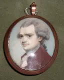 George Engleheart, A Gentleman, wearing plum-coloured coat over cream waistcoat and frilled white cravat, his powdered hair curled and worn en queue, yellow metal oval frame, the rear with blue silk,