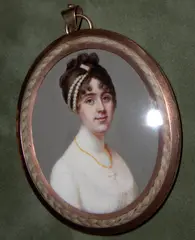 Robert Saunders, A Lady, wearing white dress, a cross pendant on a string of amber beads around her throat, her brown hair curled and upswept and dressed with strands of pearls., yellow oval metal frame with plaited hair border,