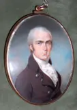 Philip Jean, A Gentleman, wearing brown coat with silver buttons over frilled white cravat, oval yellow metal frame, the rear with arranged hair,