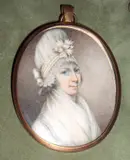 Circle of John Bogle, A Lady, wearing white dress with tucker, her curled and powdered hair upswept beneath a high pleated white bonnet trimmed with pale pink ribbons, yellow metal oval frame,