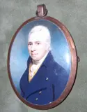 Charles Hardy, A Gentleman, wearing blue coat with brass buttons over cream waistcoat and tied white stock, signed and dated 1802, yellow metal oval frame, the rear with initials 'AB'