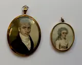 English School, A Gentleman, wearing blue coat and tied white cravat, yellow metal oval frame, the rear with arranged hair, together with another smaller example of a female subject,