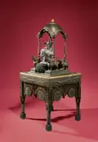 Silberelefant unter Baldachin auf einem Tisch von Carlo Bugatti (1856–1940) by Hofwerkstätten der Maharawal von Dungarpur, 1880, Holz; Messingblech, gestanzt; Pergament; Silber, gegossen, getrieben; Gelbguss, ziseliert – Silberelefant hergestellt in, sold Nov 2017