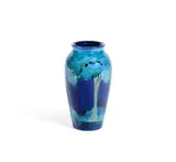 A 'Moonlit Blue' Vase by William Moorcroft, circa 1925, of slender ovoid form, painted with trees in a landscape, glazed in tones of blue, sold Aug 2020