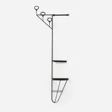 Jacques Adnet, Wall rack, c. 1955, saddle-stitched leather over enameled iron