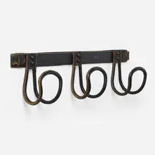 attribution Jacques Adnet, Coat rack, c. 1955, saddle-stitched leather over steel