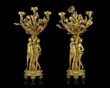 Étienne Maurice Falconet, and derived from designs by Gabriel de Saint Aubin (French, 1720-1780): A pair of 19th century gilt bronze three-light figural candelabra, gilt bronze