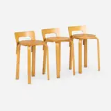 L-leg stools, set of three by Alvar Aalto, laminated birch, birch, sold Aug 2026
