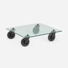 Tavolo Con Ruote coffee table by Gae Aulenti, 1980, glass, enameled steel, rubber, sold Jul 2026