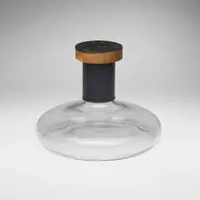 Carl Auböck, Rare decanter with stopper, c. 1950, glass, embossed and gilt leather, cork, mahogany