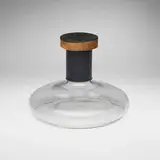 Carl Auböck, Rare decanter with stopper, c. 1950, glass, embossed and gilt leather, cork, mahogany