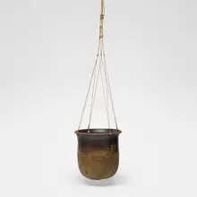 Hanging planter by Toshiko Takaezu, c. 1967, glazed stoneware, jute, sold Aug 2026
