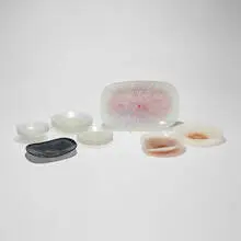 Collection of twenty-one tablewares by Maurice Heaton, c. 1975, fused glass with enamel, sold May 2026
