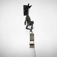 Blackman Cruz Workshop, Thieving Monkey, Right-Handed wall lamp, c. 2023, cast bronze with dark patina and polished gold highlights, glass, vintage electrified miner's lamp