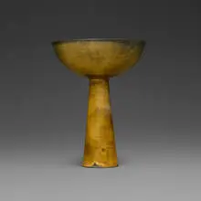 Bowl on tall conical base by Gertrud and Otto Natzler, 1962, earthenware with Tiger Eye Reduction Fired glaze, sold Jun 2026