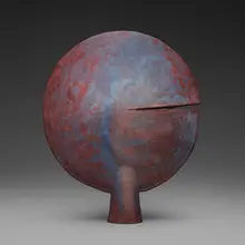 Split disk form by Otto Natzler, 1990, earthenware with Sang and Blue Reduction Fired glaze with iridescence, flame marks, and melt fissures, sold Jun 2026