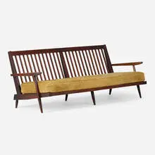 Settee with arms by George Nakashima, 1965, American black walnut, upholstered cushions, sold Apr 2026