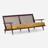 Settee with arms by George Nakashima, 1965, American black walnut, upholstered cushions, sold Apr 2026