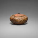 Closed form by Gertrud and Otto Natzler, 1969, earthenware with Orange Red Crater glaze, sold Jan 2026