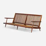 Special-order Settee with Arms by George Nakashima, 1968, American black walnut, upholstered cushions, sold Jan 2026